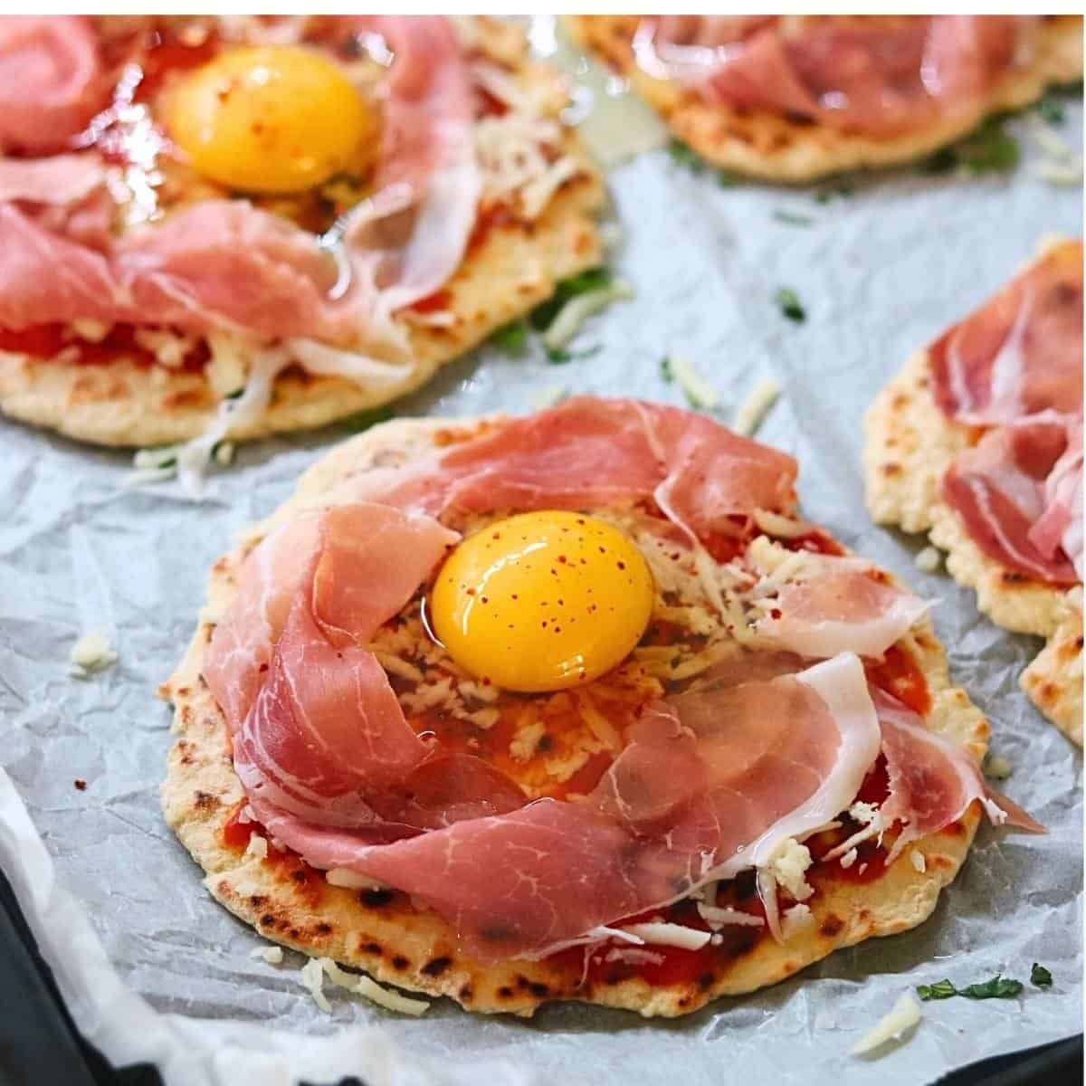 pouring raw egg in center of naan.