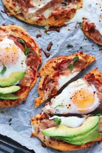 naan pizzas on baking sheet.