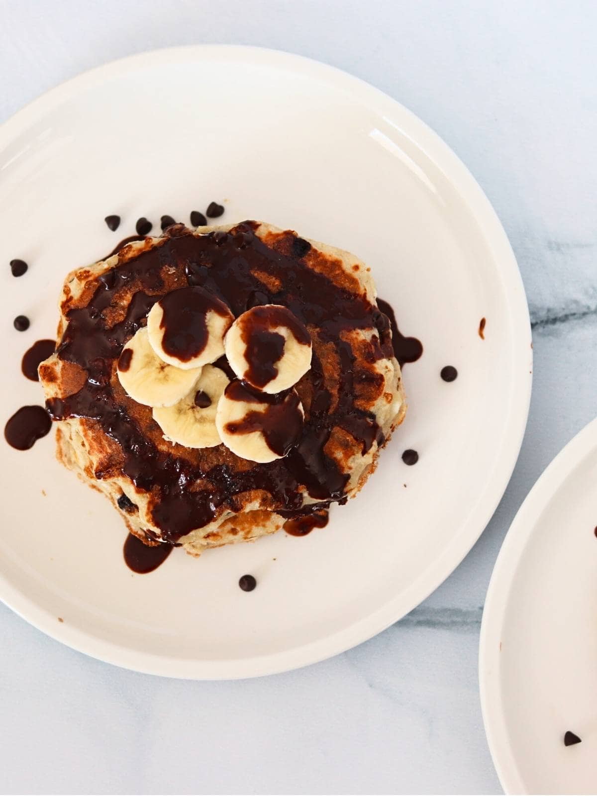 Close-up of one protein pancake topped with yogurt and chocolate drizzle